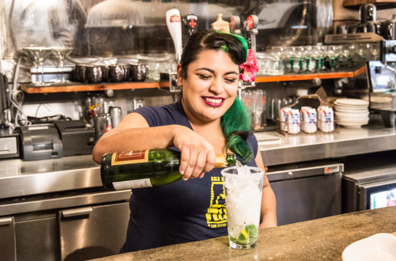 bartender pouring a drink at a bar