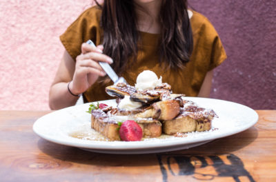 woman eating Hash House french toast